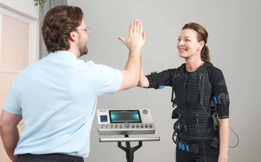 Coach and member high-fiving after an EMS session